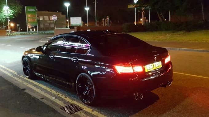 Black BMW M5 showing deep ceramic gloss finish at night — ceramic protection, Bolton